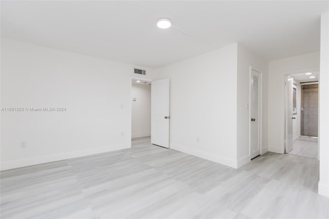 spare room with light hardwood / wood-style flooring