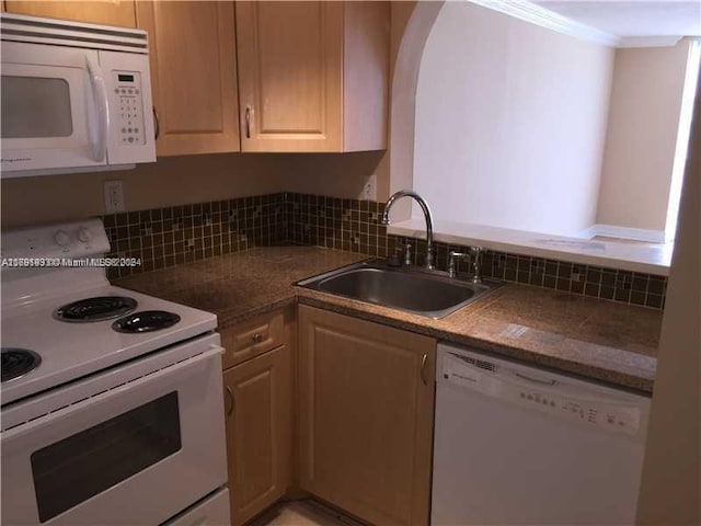 kitchen with white appliances, light brown cabinetry, sink, and crown molding