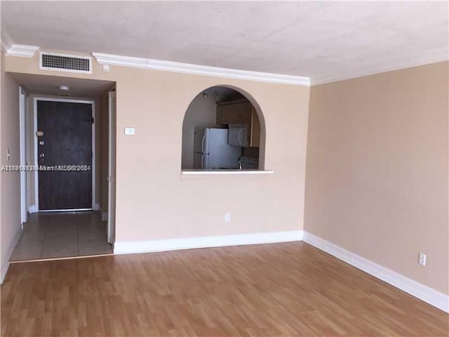 unfurnished room featuring dark hardwood / wood-style floors and ornamental molding