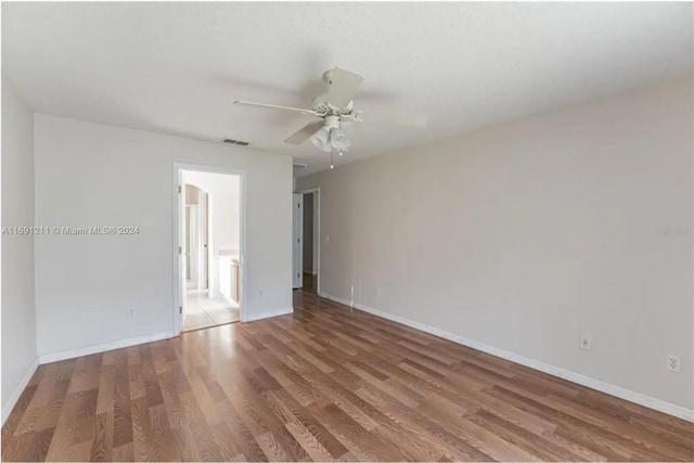 unfurnished room with hardwood / wood-style flooring and ceiling fan