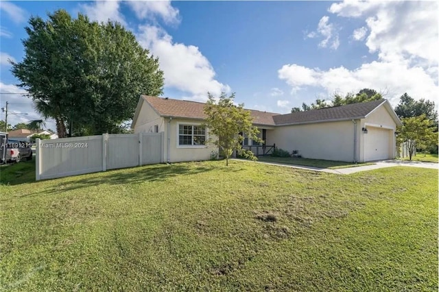 ranch-style house featuring a garage and a front lawn