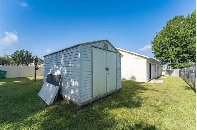 view of outdoor structure featuring a lawn