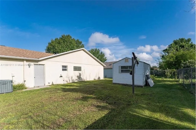 exterior space with central AC and a yard