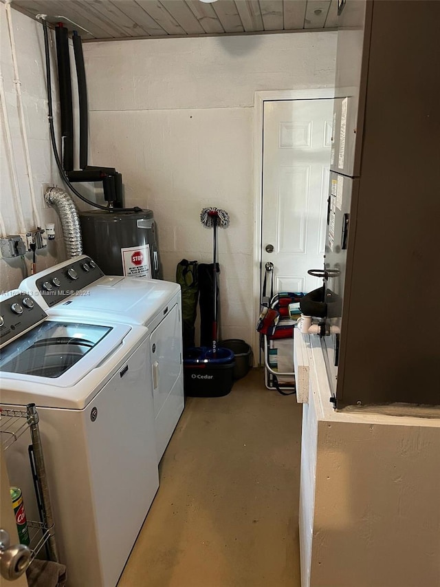 washroom featuring washing machine and dryer and water heater