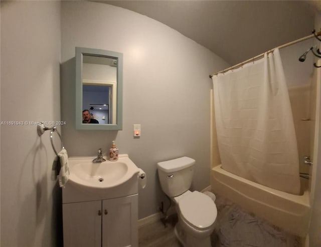 full bathroom with vaulted ceiling, vanity, shower / bath combo, and toilet