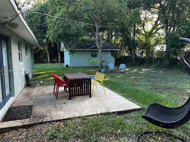 view of yard featuring a patio area and an outbuilding