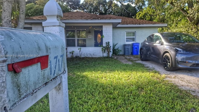 view of side of home with a yard