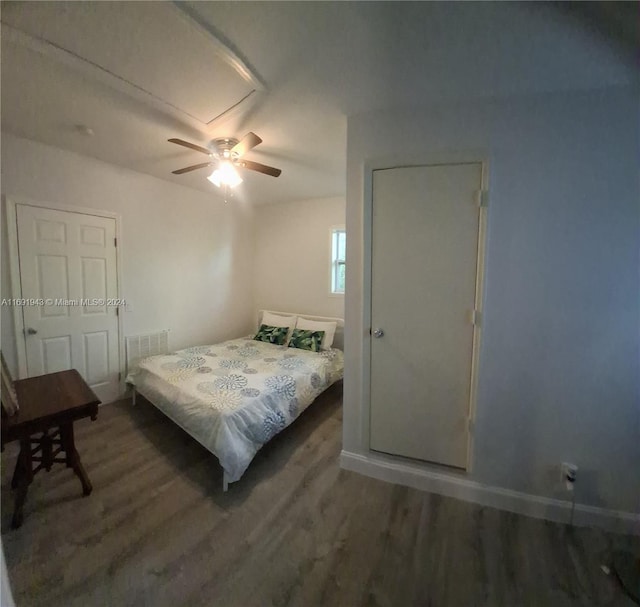 bedroom with ceiling fan and dark hardwood / wood-style floors