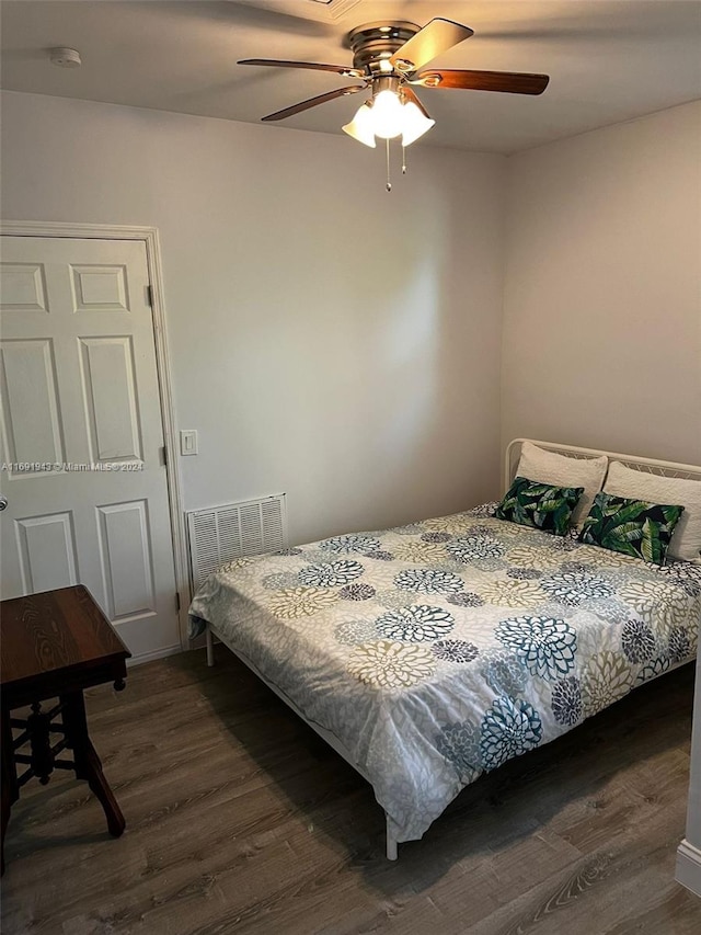 bedroom with ceiling fan and dark wood-type flooring