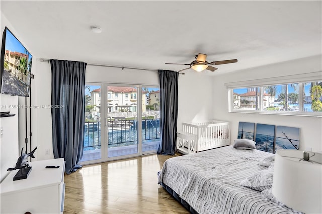 bedroom with access to outside, ceiling fan, and light wood-type flooring