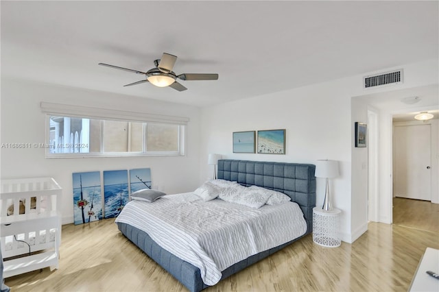 bedroom with light wood-type flooring and ceiling fan