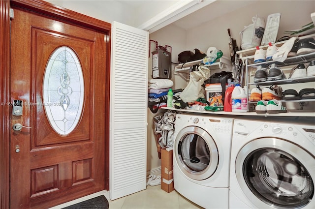 laundry room with ornamental molding, light tile patterned floors, and independent washer and dryer