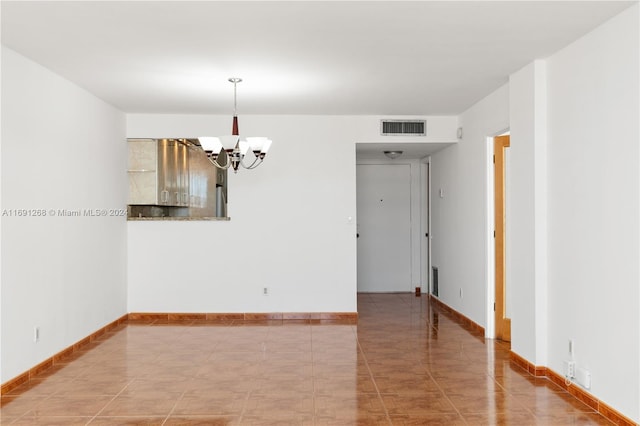 empty room featuring a notable chandelier