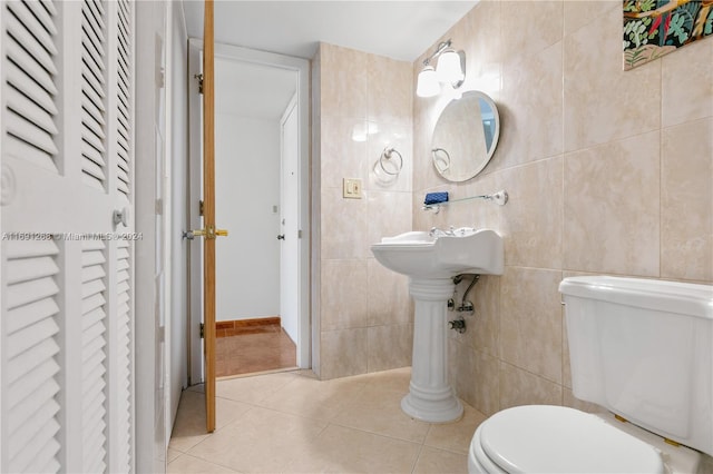 bathroom featuring toilet, tile walls, and tile patterned floors