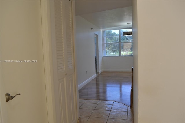 hall featuring light tile patterned floors