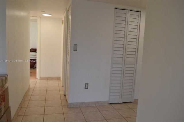 hall with light tile patterned flooring