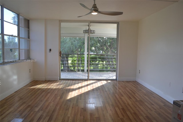 unfurnished room featuring ceiling fan and dark wood-type flooring