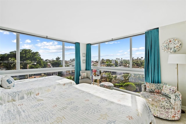 bedroom featuring multiple windows and a wall of windows