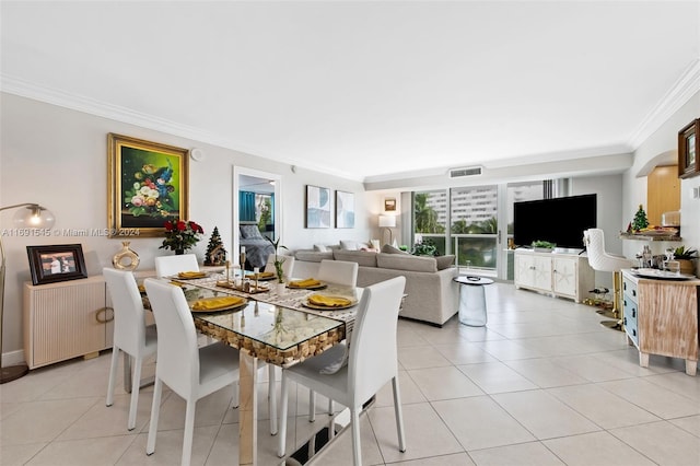 tiled dining room with radiator heating unit and crown molding