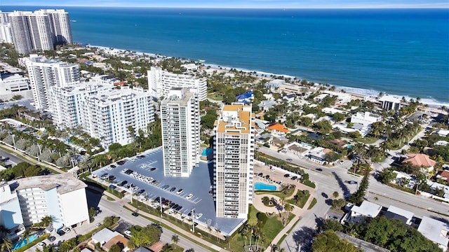 birds eye view of property with a water view and a beach view