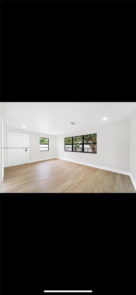 unfurnished living room with light hardwood / wood-style flooring