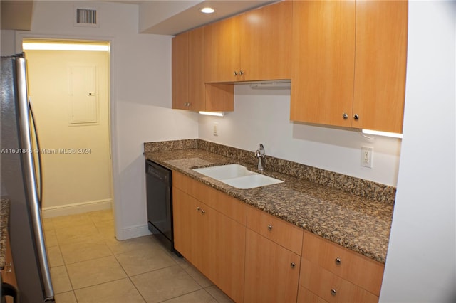 kitchen featuring light tile patterned flooring, stainless steel fridge, sink, dishwasher, and dark stone countertops