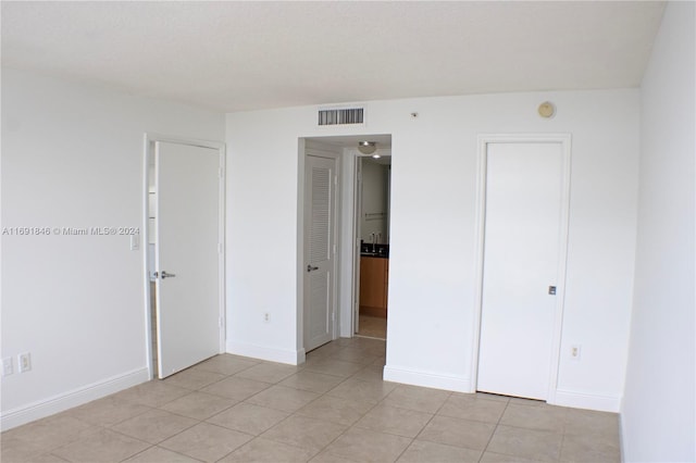 unfurnished bedroom with light tile patterned floors