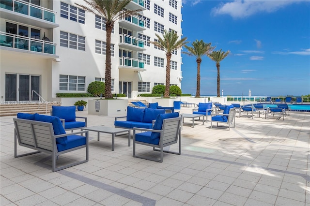 view of patio with a water view and an outdoor living space