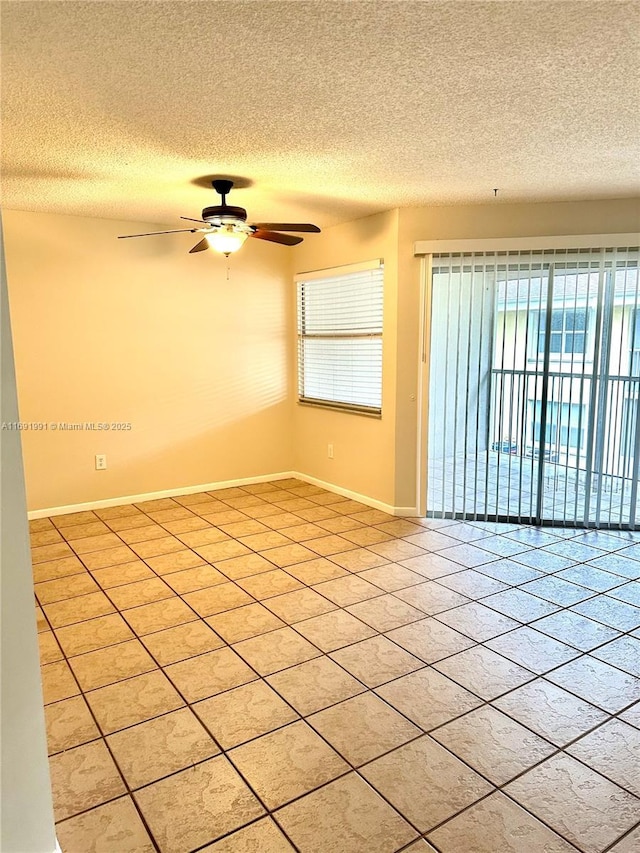 spare room featuring light tile patterned flooring, ceiling fan, and a textured ceiling