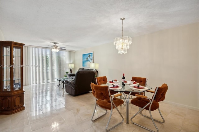 dining room featuring light tile patterned floors, ceiling fan with notable chandelier, and a textured ceiling