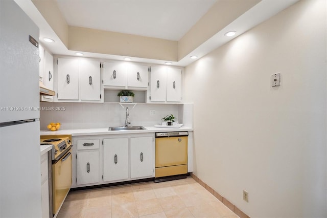 kitchen featuring white fridge, electric range, sink, white cabinets, and dishwashing machine