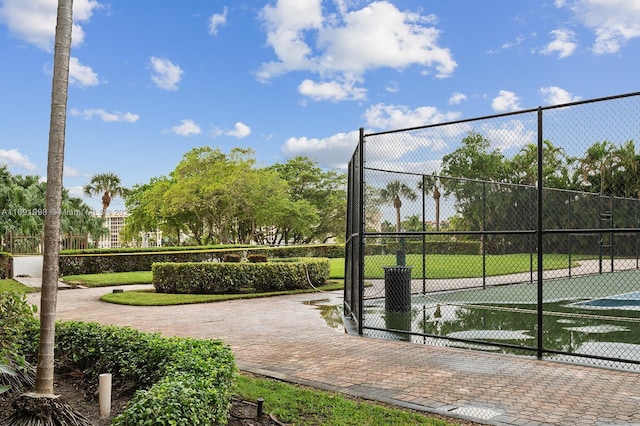 view of property's community featuring tennis court