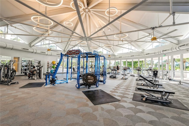 exercise room featuring high vaulted ceiling, ceiling fan, and carpet flooring