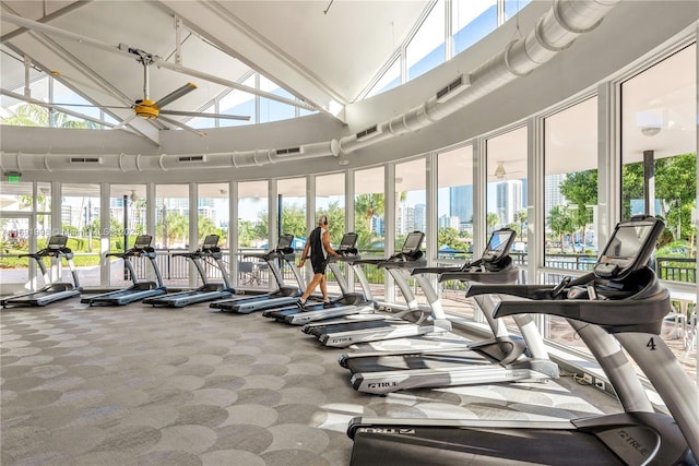 gym featuring ceiling fan, carpet floors, and high vaulted ceiling