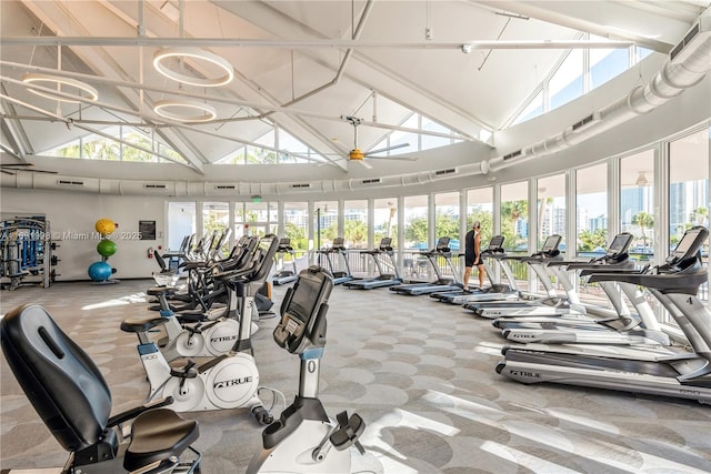 gym with ceiling fan, carpet, and high vaulted ceiling