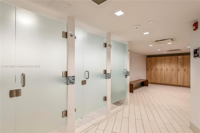 bathroom with walk in shower and wood walls