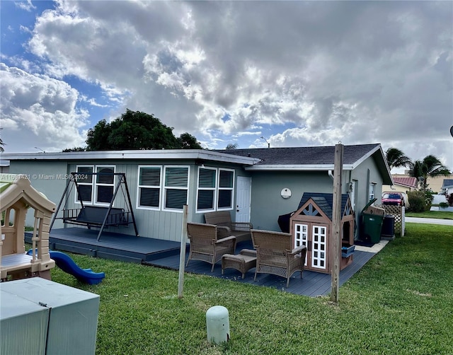 back of property with an outdoor hangout area, a lawn, and a deck