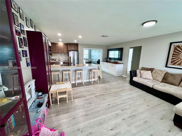 living room with light hardwood / wood-style flooring