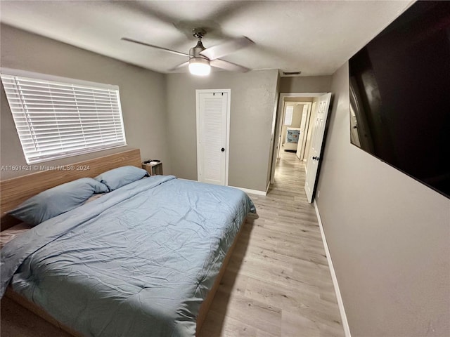 bedroom with a closet, ceiling fan, and light hardwood / wood-style flooring