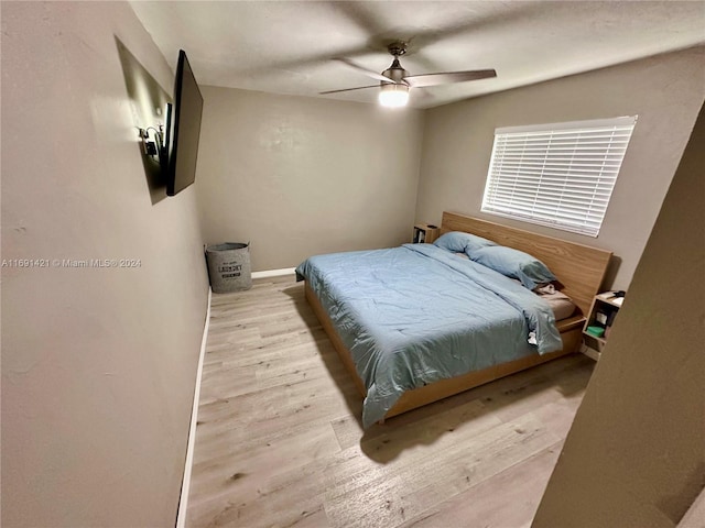 bedroom with light wood-type flooring and ceiling fan