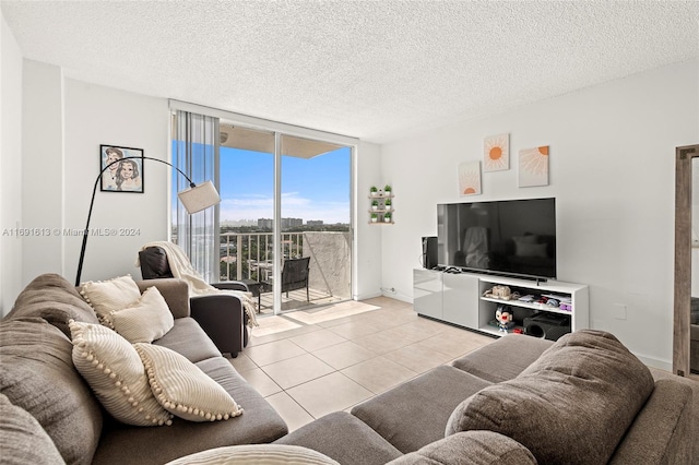 living room featuring floor to ceiling windows, a textured ceiling, and light tile patterned floors