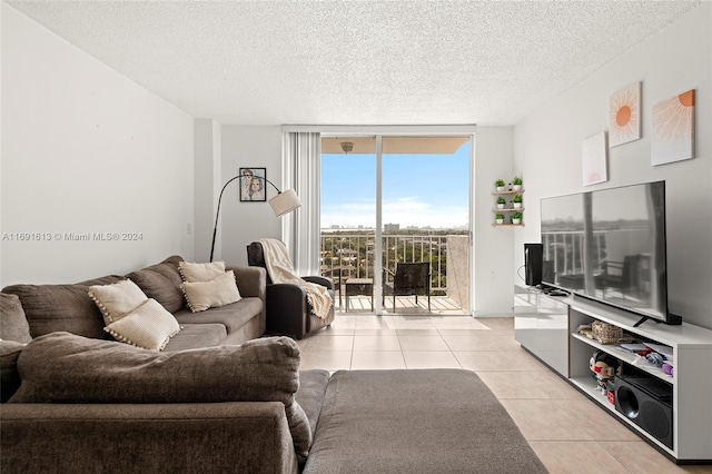 tiled living room with floor to ceiling windows and a textured ceiling