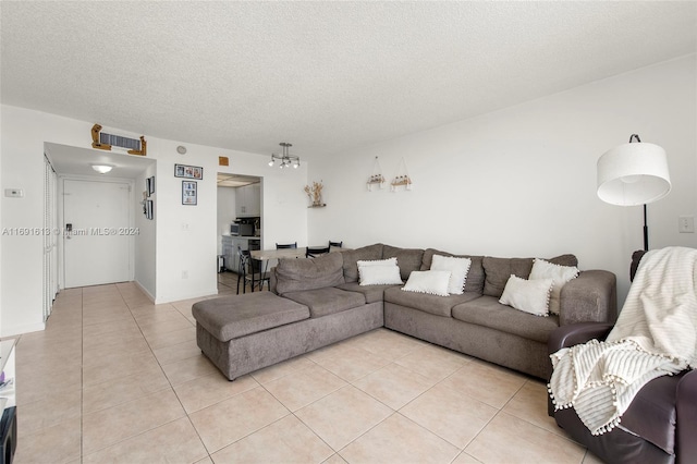 tiled living room featuring a textured ceiling