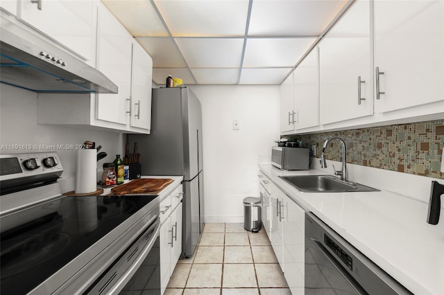 kitchen featuring stainless steel appliances, white cabinetry, sink, and decorative backsplash