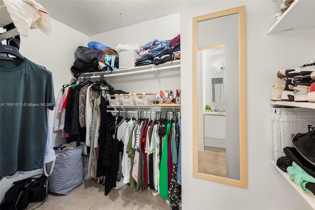 walk in closet featuring light tile patterned flooring