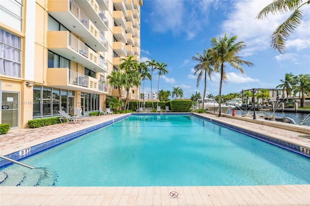 view of swimming pool with a water view