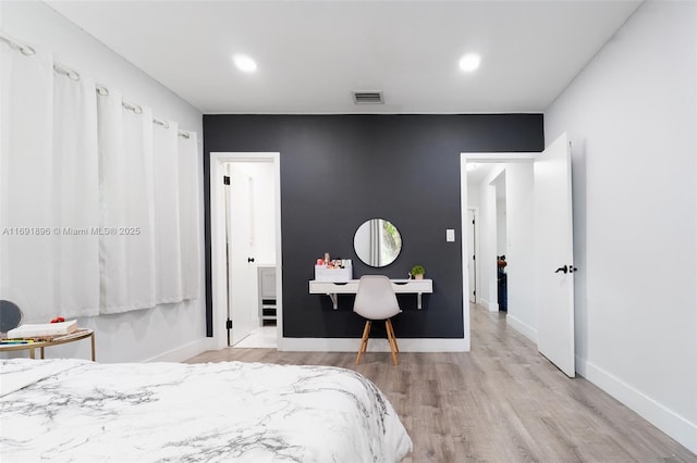 bedroom with light wood-type flooring