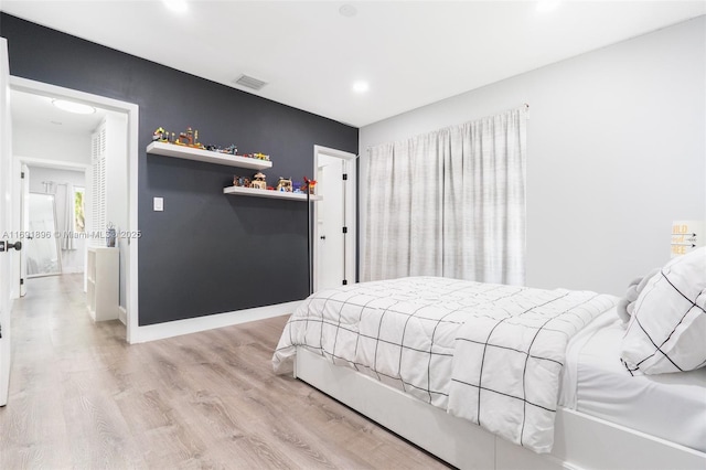 bedroom with light hardwood / wood-style floors