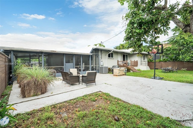 back of house with a lawn, a sunroom, a patio, and central air condition unit