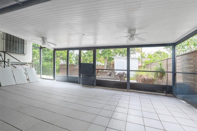 unfurnished sunroom with ceiling fan and a healthy amount of sunlight